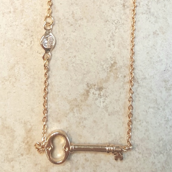 Jewelry - Key pendant necklace with rhinestone accent.